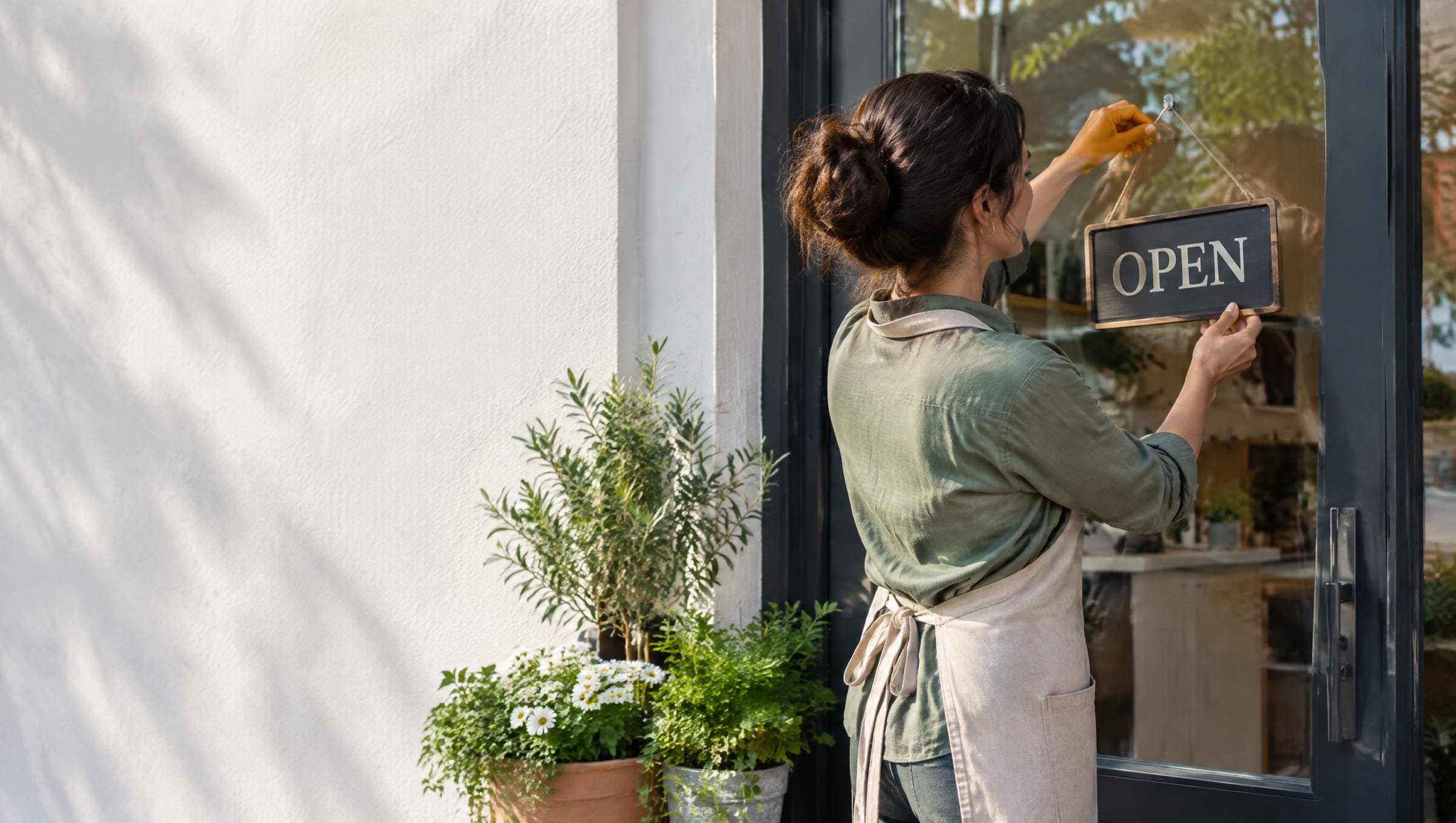 Shop owner turning the door sign to Open